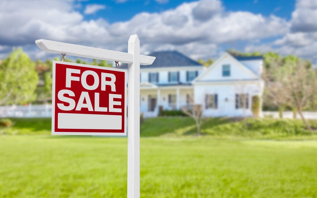Home For Sale Real Estate Sign in Front of Beautiful New House
